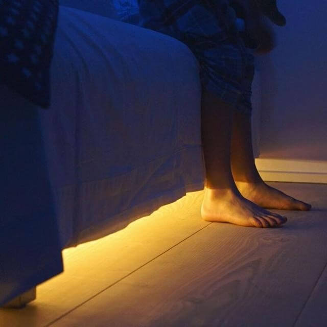 strip lights at the bottom of the bed